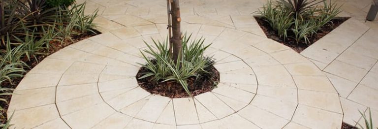 Pavers are easy to cut for example around trees & garden beds