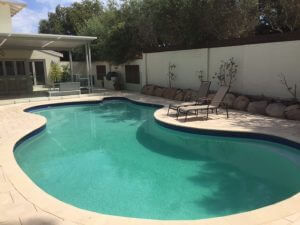 Traditional style curved pool with Beach Champagne pavers & bullnose
